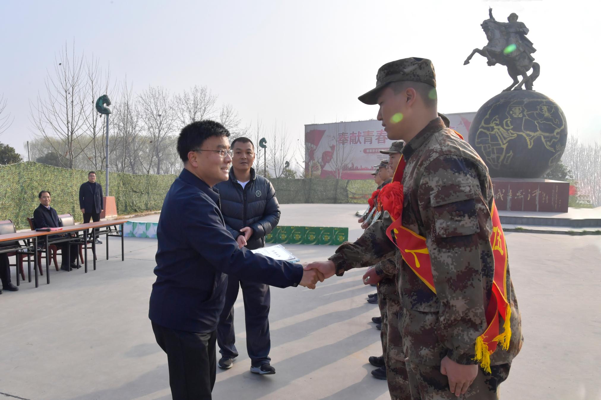 1副校长刘红林为新兵颁发南阳师范学院“优秀大学生”奖牌.jpg